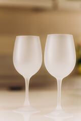 Two empty frosted wine glasses