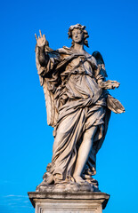 Angel with the Nails statue by Girolamo Lucenti on Ponte Sant'Angelo Saint Angel Bridge over Tiber river in historic center of Rome in Italy