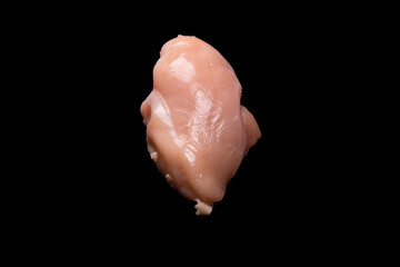 Raw chicken fillet isolated on a black background.