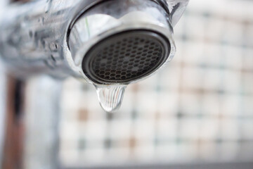 Close up faucet with water drop