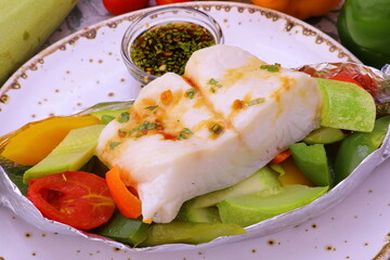 fish baked with vegetables steamed in foil gourmet menu 