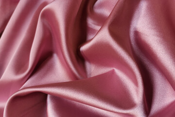 Pink crumpled or wavy fabric texture background. Abstract linen cloth soft waves. Silk atlas or...
