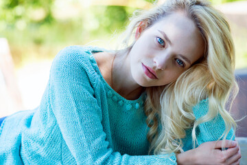Spring portrait of a girl with blue eyes in nature
