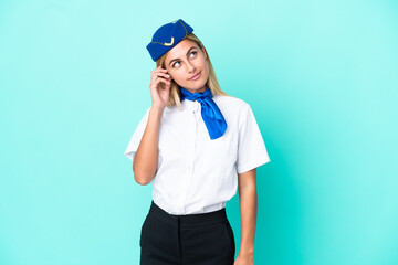 Airplane stewardess Uruguayan woman isolated on blue background thinking an idea