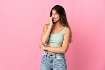 Young caucasian woman isolated on pink background is a little bit nervous