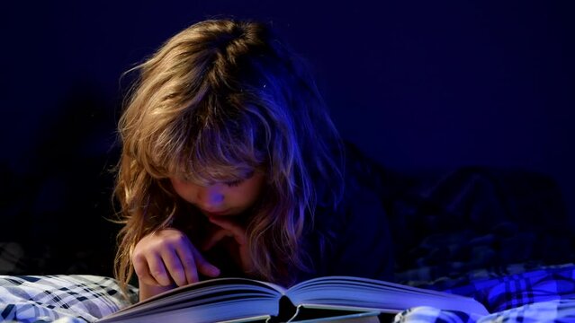 Child reading book. Kids read books. Little boy sitting on in living room watching pictures in story book. Kid doing homework for elementary school. Children study.