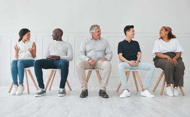 We can learn a lot by listening to each others stories. Shot of a diverse group of people talking to each other while sitting in line against a white background. - Powered by Adobe