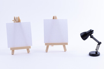 Two Wooden Easels Miniature with Blank White Square Canvas for Artists and Painters - Mockup. Mini...