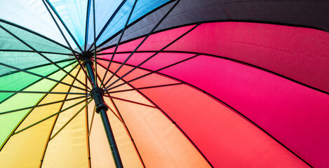 Rainbow color umbrella background. Multicolored spectrum colours sunshade, open, sunny day © Rawf8