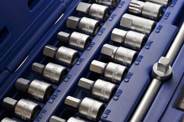 Open toolbox with different metal tools for car repair, close up.