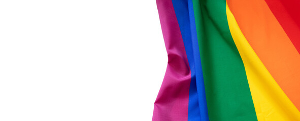 Rainbow colors textile on white background, copy space. LGBT Gay pride template, top view, banner.