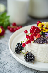 fresh ricotta with berries and flowers
