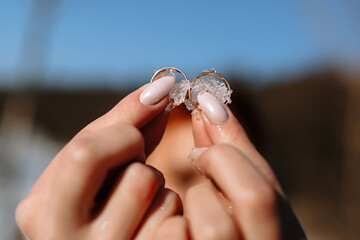 Wedding rings in the snow. Wedding rings in the hands of the bride