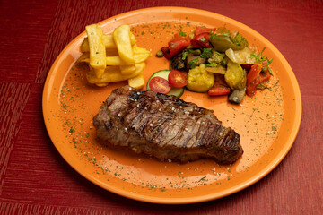Juicy veal fillet with vegetables and french fries