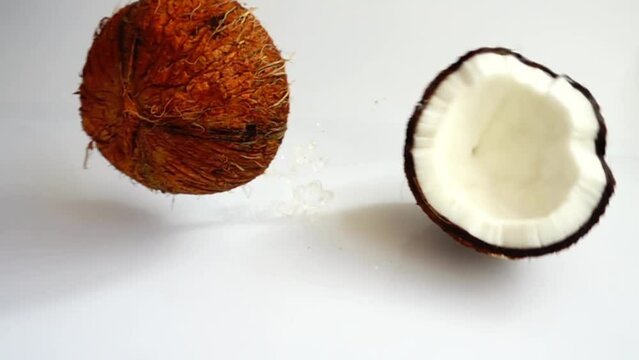 Falling ripe and juicy coconut. Slow motion.