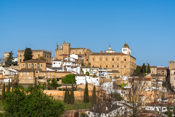 cityscape view of the historic old city center of Caceres under a blue sky