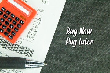 calculator, receipt and pen with the words Buy now pay later