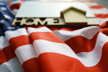 House symbol on the American flag. Mortgage credit lending. Housing safety.