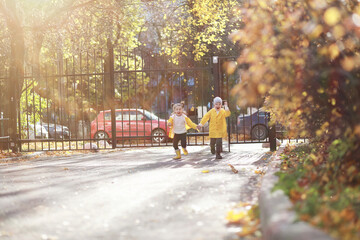 Children walk in the autumn park