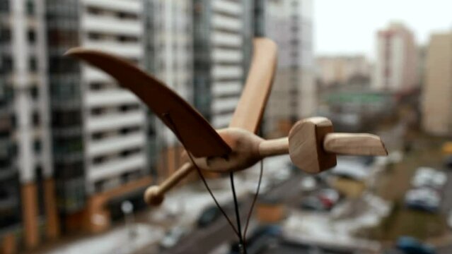 toy wooden bird flies over the city automaton 