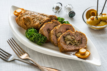 Stuffed pork minced meat with mushrooms on wooden table
