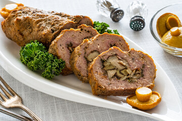 Stuffed pork minced meat with mushrooms on wooden table
