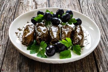 Dolmades Greek wraps on wooden table

