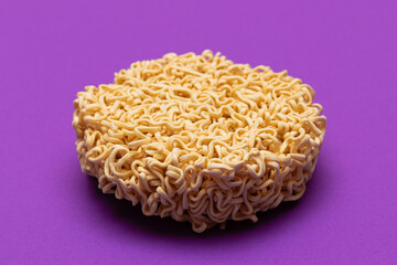 Uncooked Instant Noodles on Violet Background. Raw Pasta. Dry Asian Fast Food. Quick Lunch