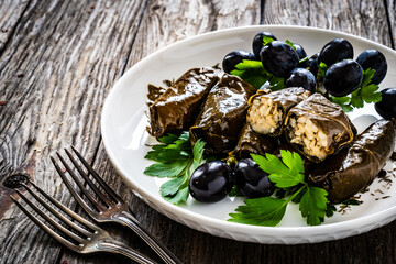Dolmades Greek wraps on wooden table


