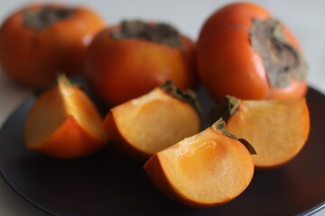 Sliced amarphal. Persimmon or amarphal is a fruit native to Japan, China, Korea, Burma, Nepal and in some parts of India.