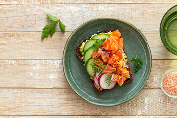 toast with rye bread, salmon, avocado