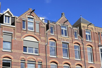 Fototapeta na wymiar Amsterdam Paulus Potterstraat Street House Facades with Pointed Gables Against a Bright Bue Sky, Netherlands