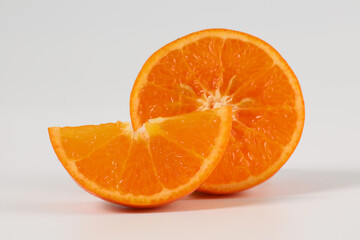 oranges, halved oranges, healthy fruit, mandarin oranges, vitamin C, against white background with refreshing water droplets