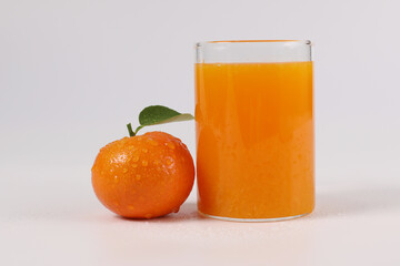 oranges, healthy fruit, mandarin oranges, orange juice in glass, vitamin C, against a white background with refreshing drops of water