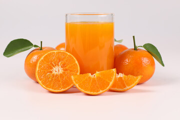 oranges, healthy fruit, mandarin oranges, orange juice in glass, vitamin C, against a white background with refreshing drops of water
