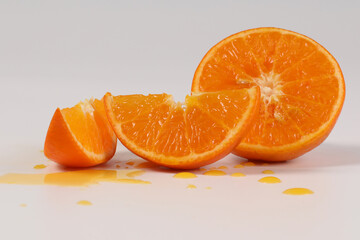 oranges, halved oranges, healthy fruit, mandarin oranges, vitamin C, against white background with refreshing water droplets