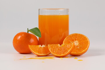 oranges, healthy fruit, mandarin oranges, orange juice in glass, vitamin C, against a white background with refreshing drops of water
