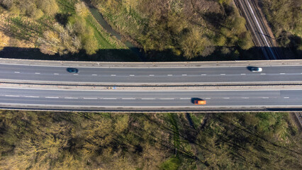 A high angle view of traffic on a dual carriageway passing next to Stowmarket in Suffolk, UK - obrazy, fototapety, plakaty