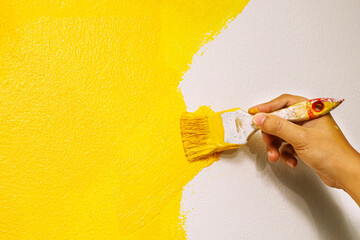Paint brush, close up hand painter worker painting on surface wall Painting apartment, renovating...