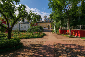 View of the Assumption Cave and Pokrovsky temples, the Sretensky Church and the sacristy of the Svyato-Uspenskiy Pskov-Pechersky Monastery on a sunny summer day, Pechory, Pskov region, Russia