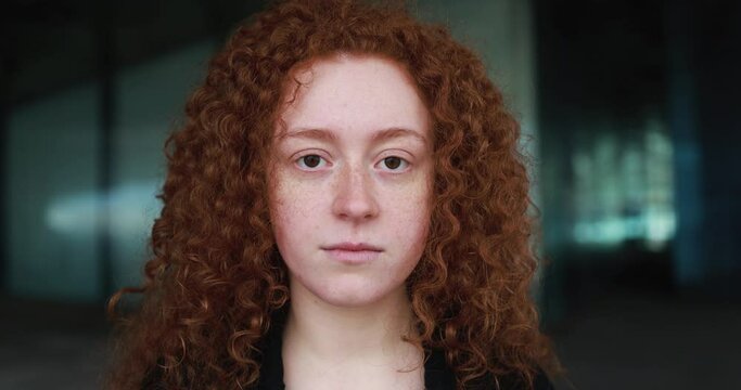 Readhead girl looking on camera outdoor