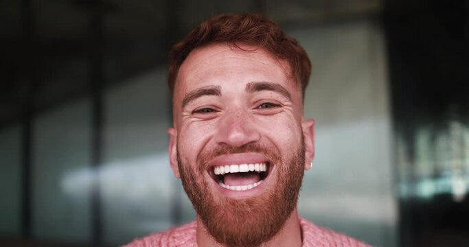 Young happy man smiling on camera outdoor - Focus on face