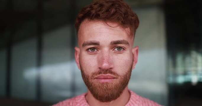 Young man looking on camera outdoor 