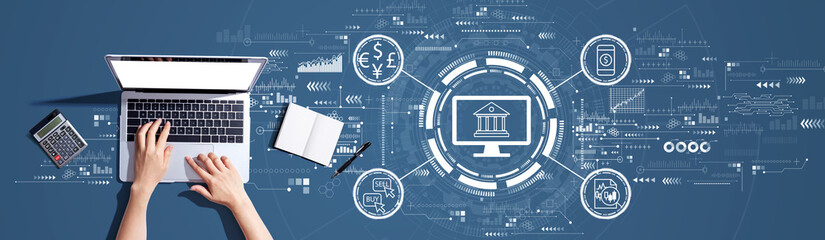 Fintech theme with person using a laptop computer