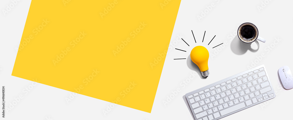 Poster computer keyboard with a yellow light bulb from above