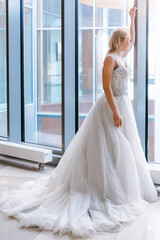 Bride with short hair and in a white puffy dress poses for the camera