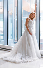 Bride with short hair and in a white puffy dress poses for the camera