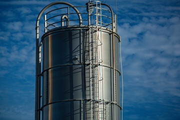 Stainless steel silos in the chemical industry, bulk plastics silo against