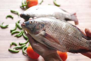 top view of raw fresh fish on hand 