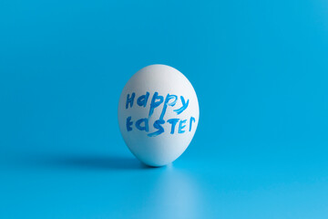 White egg  with text on a blue background.